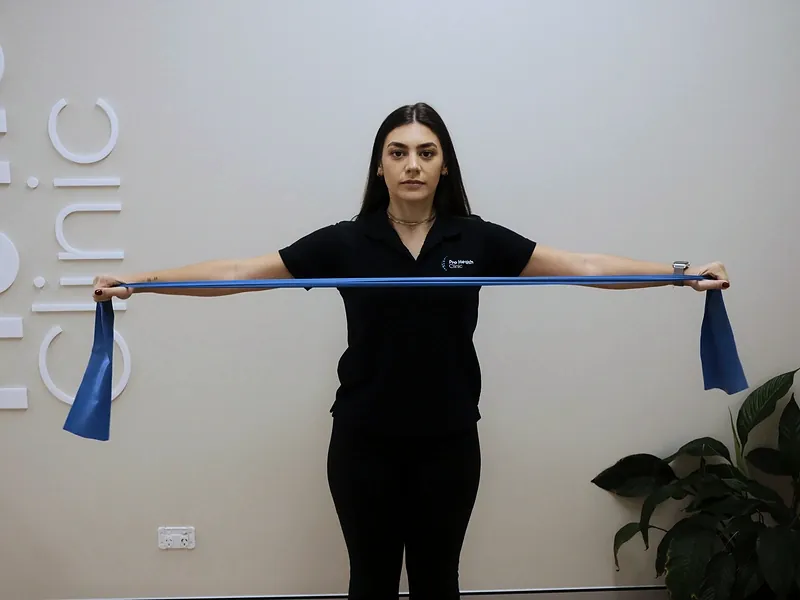 Practitioner demonstrating a resistance band exercise