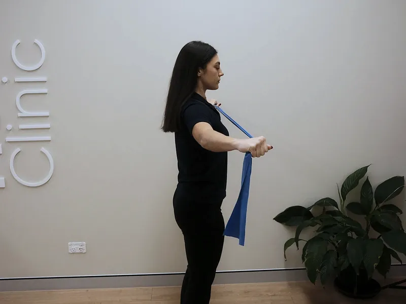 Practitioner demonstrating a resistance band movement