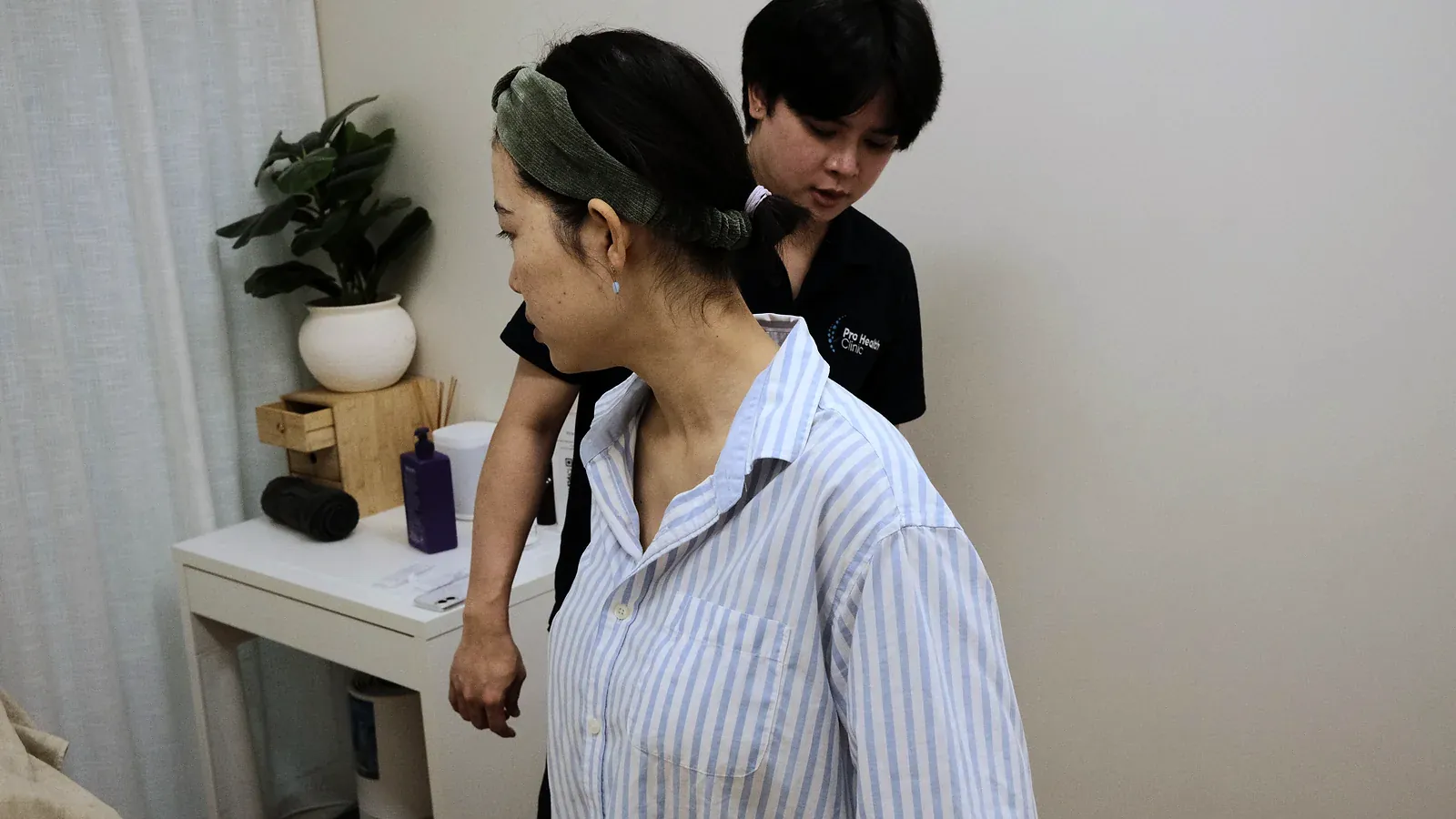 Practitioner assessing a patient’s standing posture